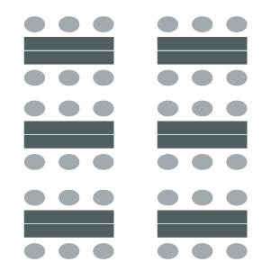 Classroom setup with rows of tables and chairs on both sides