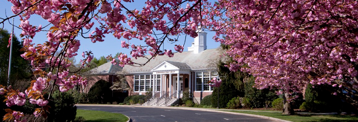 Harborfields Public Library exterior during the Springtime with flowers in bloom