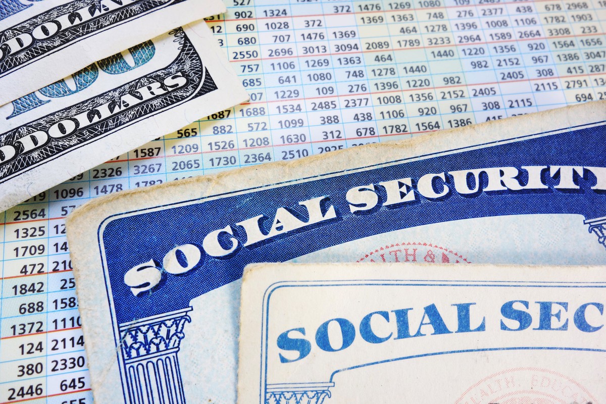 Social Security cards, money, spreadsheet