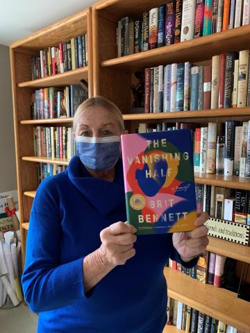 Discussion leader Donna Diamond holding the Long Island Reads Selection