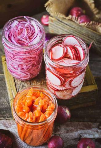 image of pickled red onion, carrots and radishes